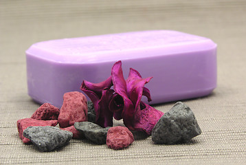 Image showing Lilac soap with decoration articles on a  gray  background