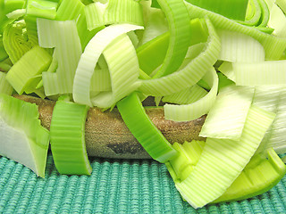 Image showing SLiced green leek on a wooden plate