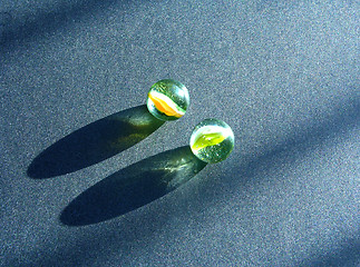 Image showing Two transparent marbles on a dark underground with shawows