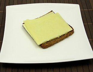 Image showing Wholemeal bread with two slices of cheese on a plate 