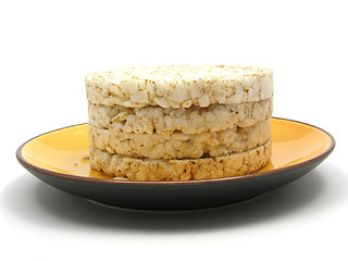 Image showing Slices of puffed rice arranged on a bowl of ceramik on white