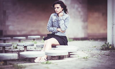 Image showing Girl on bench in denim jacket