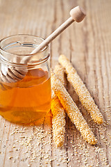 Image showing grissini with sesame seeds and honey