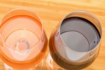 Image showing Glasses of Red and Pink Wine on Wooden Table