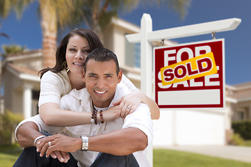 Image showing Hispanic Couple, New Home and Sold Real Estate Sign