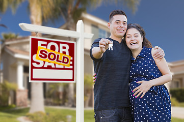 Image showing Hispanic Couple, Keys, New Home and Sold Real Estate Sign