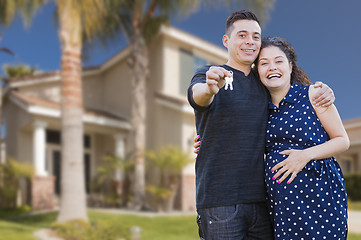 Image showing Hispanic Couple with House Keys In Front of New Home