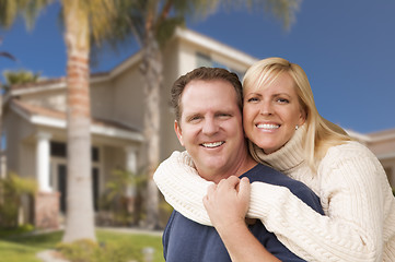 Image showing Happy Couple Hugging in Front of House