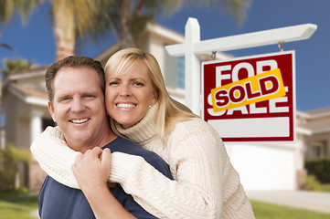 Image showing Couple in Front of Sold Real Estate Sign and House