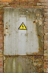 Image showing door with yellow warning sign of danger 