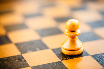 Image showing White chess pawn standing on chessboard