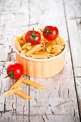 Image showing uncooked pasta and cherry tomatoes in a bowl