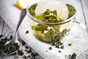 Image showing cup of green tea and lemon