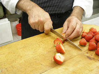 Image showing Cutting strawberries