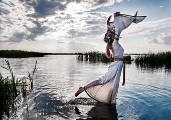 Image showing Beautiful woman with flower wreath relaxes