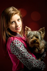 Image showing smiling young girl with her pet yorkshire