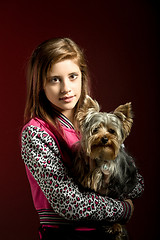 Image showing smiling young girl with her pet yorkshire