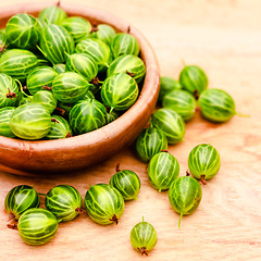 Image showing Close-Up Of Gooseberries In Vintage Wooden Bowl On Wooden Table