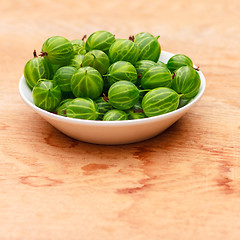 Image showing Close-Up Of Gooseberries In Vintage White Dish On Wooden Table