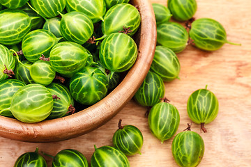 Image showing Close-Up Of Gooseberries In Vintage Wooden Bowl On Wooden Table