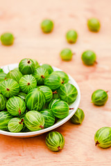 Image showing Close-Up Of Gooseberries In Vintage White Dish On Wooden Table