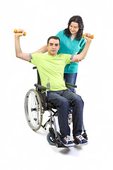 Image showing Therapist assists patient with weightlifting