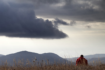 Image showing Man resting at mountains in evening