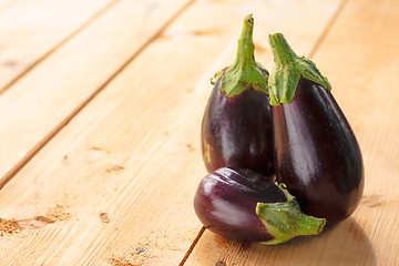 Image showing Eggplants On A Wooden Background