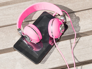 Image showing Female pink headphones and tablet pc