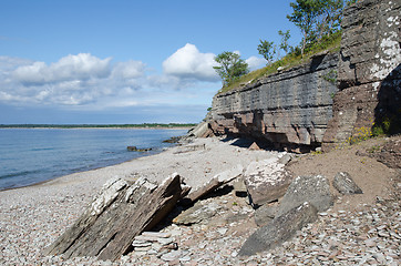 Image showing Cliffs by the coast at a calm bay