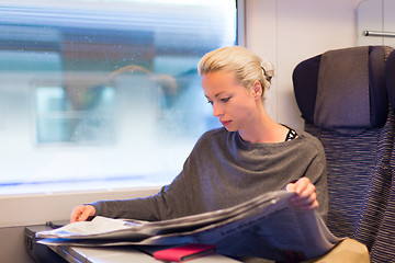 Image showing Lady traveling by train.