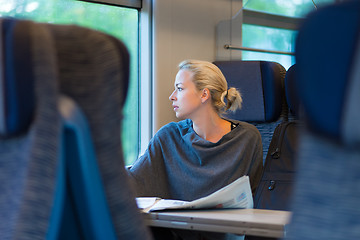 Image showing Lady traveling by train.