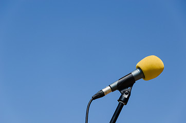 Image showing yellow microphone blue sky bakcground 