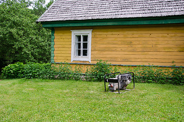 Image showing diesel electricity generator work near rural house 