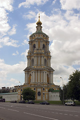 Image showing russian bell tower with clock on blue sky background