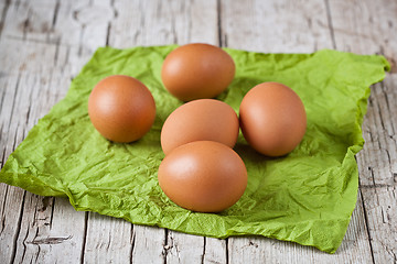 Image showing  fresh brown eggs on green napkin