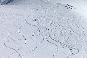 Image showing Snowboarders and skiers on off-piste slope at sun day