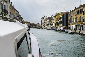 Image showing Ancient buildings and boats in the channel in Venice