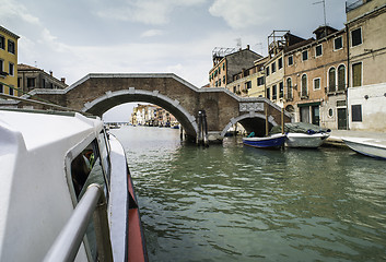 Image showing Ancient buildings and boats in the channel in Venice