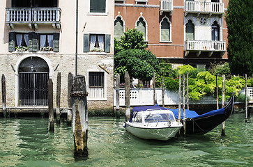 Image showing Ancient buildings and boats in the channel in Venice