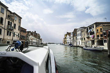 Image showing Ancient buildings and boats in the channel in Venice