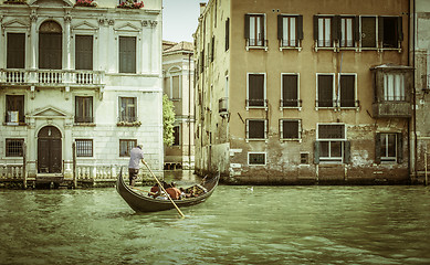Image showing Ancient buildings in Venice. Boats moored in the channel. Gondol