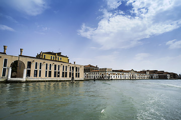 Image showing Ancient buildings in Venice. Boats moored in the channel