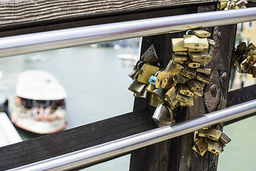 Image showing Padlocks of lovers placed on the bridge