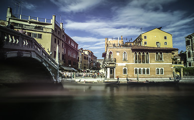 Image showing Ancient buildings and boats in the channel in Venice