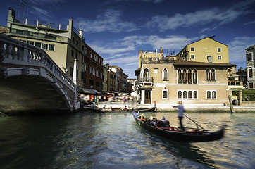 Image showing Ancient buildings and boats in the channel in Venice