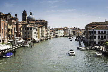 Image showing Ancient buildings and boats in the channel in Venice