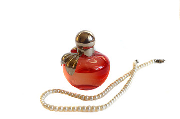 Image showing Perfume bottle and pearl beads isolated on white