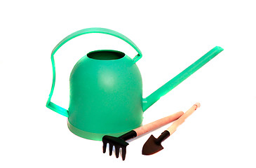 Image showing Green watering can, shovel and rake care of houseplants