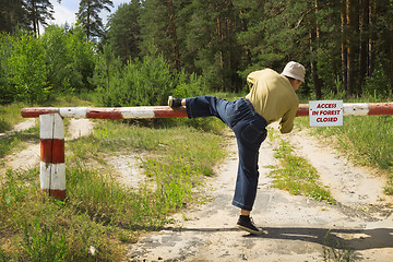 Image showing Man overcomes barrier in fire-dangerous period, ignoring ban